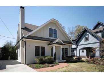 Charming brick home featuring a classic design, manicured landscaping and inviting curb appeal at 415 Fayetteville Rd, Decatur, GA 30030