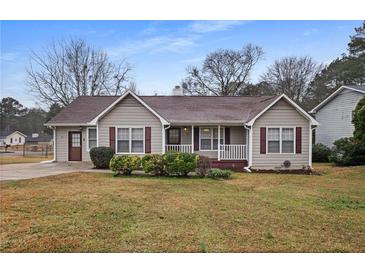 Charming home featuring gray siding, a brown roof, and well-maintained landscaping at 3645 Fay Dr, Rex, GA 30273