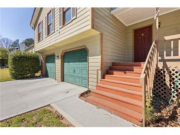 Charming home featuring a two-car garage, painted trim, and covered front porch at 1312 Brandl Sw Dr, Marietta, GA 30008