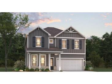 Charming two-story home featuring gray siding, black shutters, and a welcoming front porch at 2624 Mourning Dove Dr Lot 42, Grayson, GA 30017