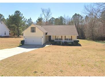 Charming single-story home boasts a well-maintained yard and attached two car garage at 775 Freeman Dr, Covington, GA 30016