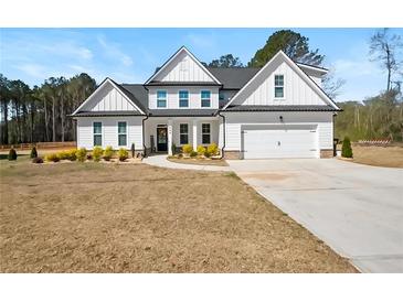 Charming two-story home with manicured landscaping and a welcoming front porch, perfect for enjoying the outdoors at 844 Pool Rd, Hiram, GA 30141