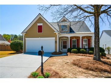 Charming home with a well-maintained lawn, red shutters, and inviting front porch at 303 Dexter Dr, Woodstock, GA 30188