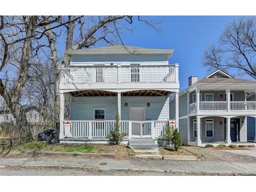 Charming two-story home featuring a welcoming front porch and an upper-level balcony, perfect for enjoying outdoor living at 73 Atlanta Sw Ave, Atlanta, GA 30315