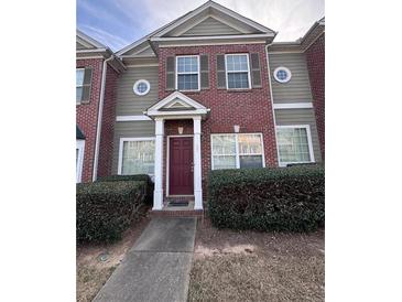 Charming two-story home features brick facade, neutral siding, and manicured landscaping at 7563 Avalon Blvd # 305, Fairburn, GA 30213