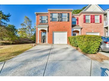 Charming two-story brick home with a one-car garage and a well-manicured lawn, perfect for families at 1526 Viero Dr, Lawrenceville, GA 30044