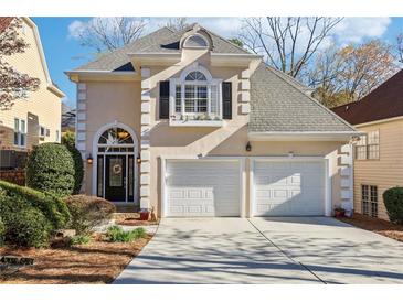 Charming two-story home featuring a two-car garage and beautifully landscaped front yard at 1056 Shady Valley Ne Pl, Brookhaven, GA 30324