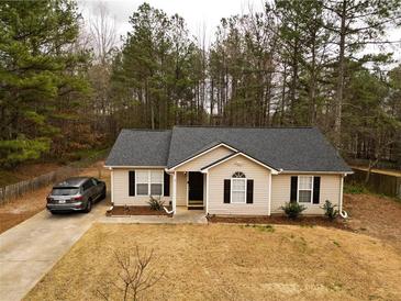 Charming single-story home featuring a well-maintained lawn, dark-shuttered windows, and a private driveway at 284 Southern Trace Way, Rockmart, GA 30153