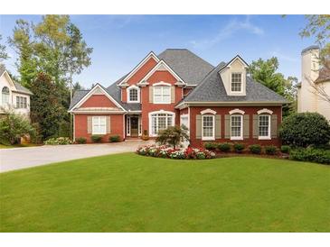 Lovely two-story brick home with manicured lawn and beautiful flower beds in a desirable neighborhood at 1009 Fairway Seven, Villa Rica, GA 30180