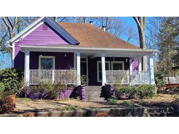 Charming purple home with a cozy front porch and white railings offers curb appeal at 885 White Sw St, Atlanta, GA 30310