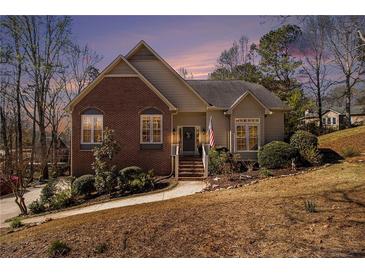 Charming home with brick and siding exterior, landscaped front yard, and inviting entrance with stairs at 5395 Steeple Chase, Douglasville, GA 30135