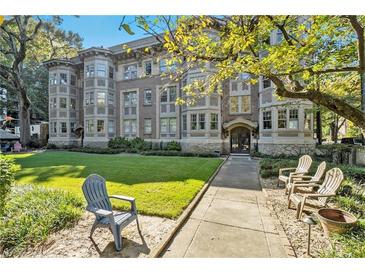 Beautiful brick multi-Gathering home featuring a lush green lawn and manicured landscaping at 1156 Piedmont Ne Ave # B3, Atlanta, GA 30309