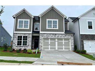 Charming new construction two-story home with stone accents and a two-car garage at 274 Lakeside Pl, Canton, GA 30114