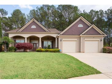 Charming single-Gathering home with a well-manicured lawn and attached two-car garage at 65 Turtle Rock Cv, Acworth, GA 30101