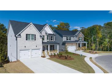 Beautiful new construction homes showcase craftsman-style architecture and inviting front yards at 1871 Lacebark Elm Way, Lawrenceville, GA 30045