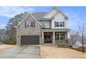 Charming two-story home with a brick facade, dark shutters, and a well-maintained front yard and driveway at 3139 Hilltop Dr, Marietta, GA 30066