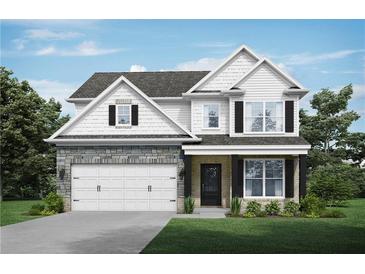 Charming two-story home featuring a stone facade, white siding, black shutters, and a manicured lawn at 3856 Lockaby Way, Lawrenceville, GA 30044