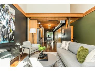Contemporary living room featuring modern furnishings, exposed beams, and polished concrete floors at 1661 La France Ne St # 314, Atlanta, GA 30307