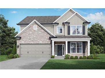 Charming two-story home featuring a brick and siding facade, attached garage, and well-manicured lawn at 3786 Lockaby Way, Lawrenceville, GA 30044