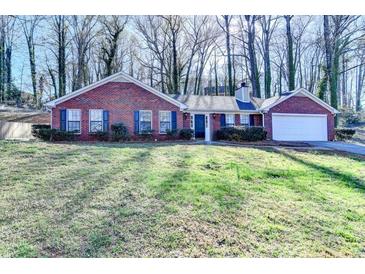 Charming brick ranch home featuring an attached garage and well-maintained lawn at 642 Dogwood Dr, Lawrenceville, GA 30046