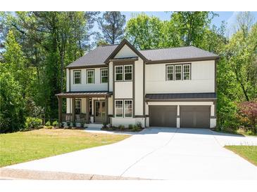 Stunning two-story home with a manicured lawn, a two-car garage, and a welcoming front porch at 2848 Tanner Lake Nw Trl, Marietta, GA 30064