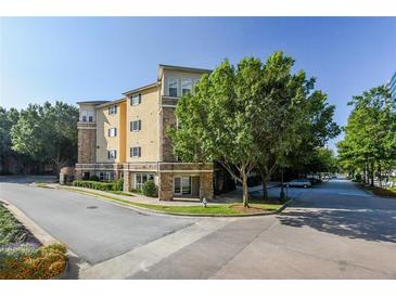 Three story condo building featuring a mix of stone and stucco exterior with street view at 10 Perimeter Summit Ne Blvd # 1208, Brookhaven, GA 30319