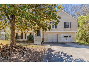 Charming home featuring a two car garage, traditional siding, and black shutters at 1270 Della Way, Lawrenceville, GA 30043