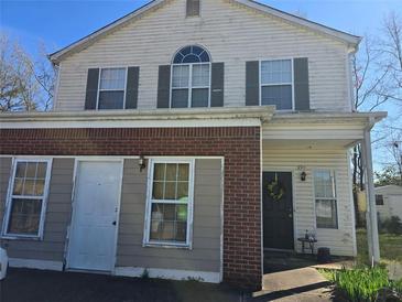 Two-story townhome featuring a brick facade, neutral siding, and a welcoming front door with decorative wreath at 2711 Teal Landing Dr, Morrow, GA 30260