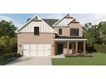 Charming brick two-story home with a two-car garage, covered porch, and manicured lawn at 380 Waterbluff Dr, Mableton, GA 30126