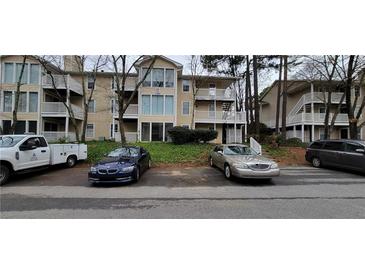 Apartment building with beige siding and a parking area at 1701 Augusta Se Dr # 1701, Marietta, GA 30067