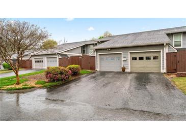 Charming townhome exterior with well-maintained garages and blossoming landscaping at 4974 Meadow Ln, Marietta, GA 30068