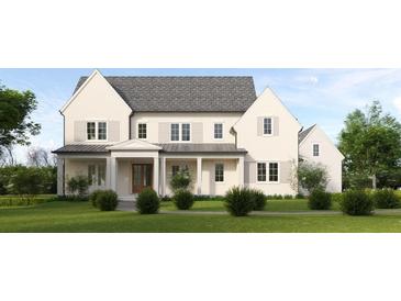 Stunning two-story home featuring a symmetrical facade, neutral color palette, and a welcoming covered front porch at 610 River Chase Rdg, Sandy Springs, GA 30328