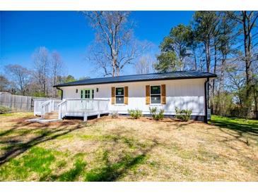 Charming home with white siding, shutters, and a lovely, inviting front porch at 116 Carroll St, Temple, GA 30179