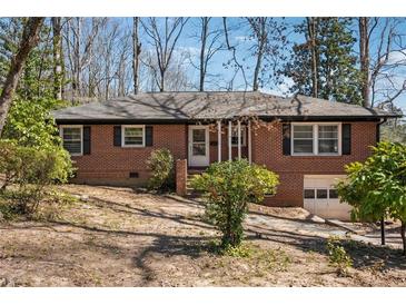 Charming brick ranch with mature trees, offering classic style and curb appeal at 2696 Dodson Dr, Atlanta, GA 30344