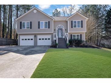 Charming two-story home features a well-manicured lawn and a two-car garage for ample parking at 3222 Pagoda Trce, Lawrenceville, GA 30043