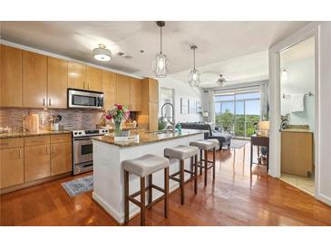 Modern kitchen with stainless steel appliances, granite countertops and a breakfast bar with seating at 711 Cosmopolitan Ne Dr # 523, Atlanta, GA 30324