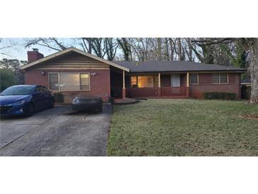 Charming single-story brick home with a cozy front porch and well-maintained lawn at 2572 Tyler Way, Decatur, GA 30032