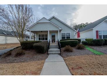 Charming single-story home with a welcoming front porch and well-maintained landscaping at 4531 Flowering Br, Powder Springs, GA 30127