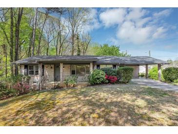 Charming brick ranch-style home with a carport and well-maintained landscaping at 9258 Westview Sw Dr, Covington, GA 30014