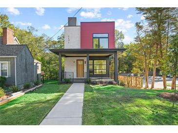 Striking modern two-story home with a covered porch, brick accents, and lush green lawn at 1171 State St # B, Atlanta, GA 30318