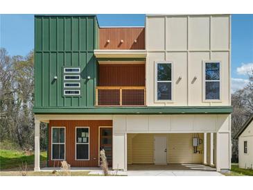 Modern two-story home featuring a covered front porch and a two-car garage at 2312 Herring Sw Rd, Atlanta, GA 30311