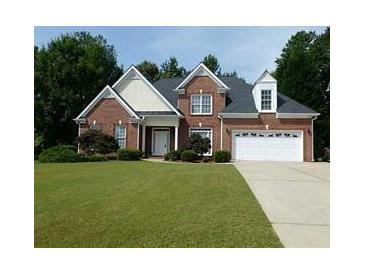 Charming brick home with a well-manicured lawn and attached two-car garage, perfect for suburban living at 275 Rose Ivy Ct, Lawrenceville, GA 30043