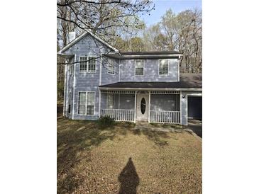 Charming two-story home with a welcoming covered front porch and a well-maintained yard at 851 Hedge Garden Ct, Stone Mountain, GA 30088