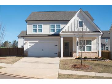 Charming two-story home featuring a white facade, attached garage, and a well-manicured front lawn at 290 Brighton Bend Ln, Acworth, GA 30102