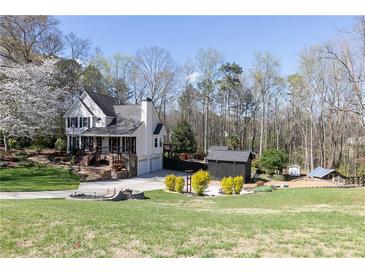 Charming two-story home with well-manicured lawn, mature trees and outbuildings at 158 Lambeth Dr, Hiram, GA 30141