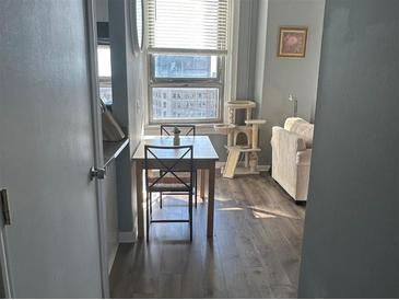 Cozy dining area with natural light and wood-look flooring in an open-concept layout at 20 Marietta Nw St # 10E, Atlanta, GA 30303