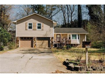Charming two-story home featuring a two-car garage and cozy front porch at 494 Rue Montaigne, Stone Mountain, GA 30083