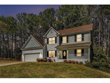 Charming two-story home with a landscaped front yard and a welcoming porch at 2404 Caneridge, Marietta, GA 30064