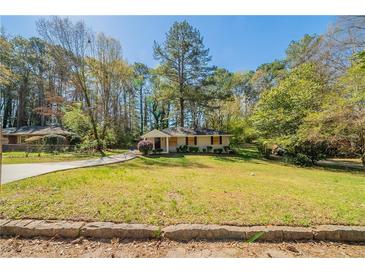 Charming single-story home features a well-manicured lawn and a welcoming walkway at 3645 Larkspur Ter, Decatur, GA 30032