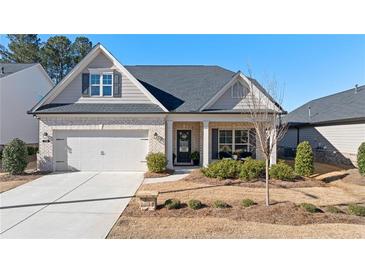 Charming single-Gathering home with a manicured lawn, brick accents, and a welcoming front porch at 130 Brayden Park Dr, Canton, GA 30115